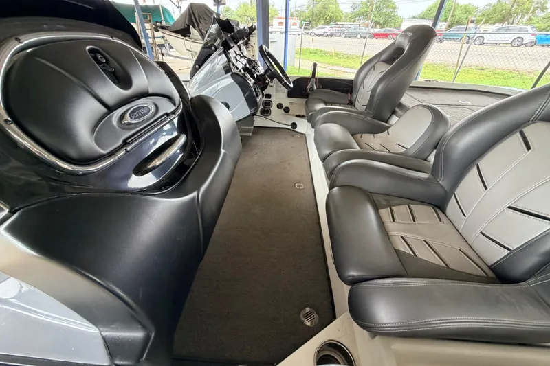 Slide: The Image of Interior of a 2016 Nitro Z20 boat featuring sleek black and gray seating. - 7