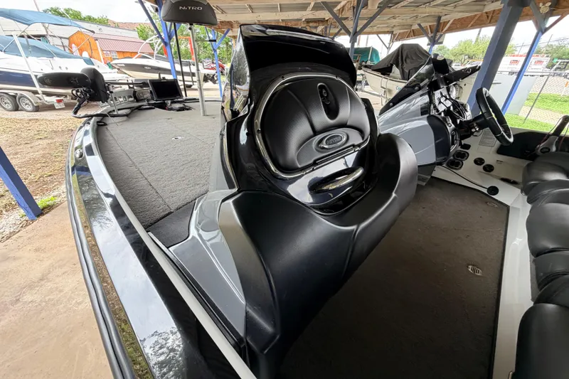Slide: The Image of 2016 Nitro Z20 boat interior with steering console and seating under a covered area. - 8