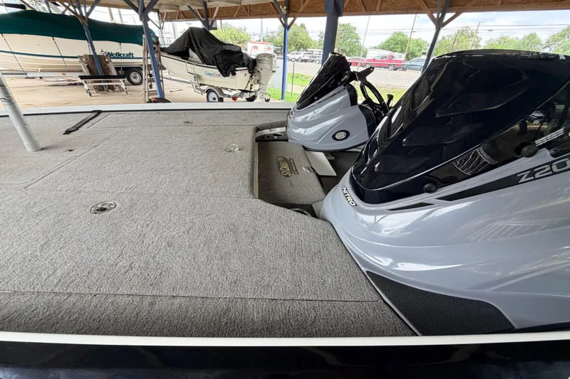 Slide: The Image of 2016 Nitro Z20 boat with carpeted deck and dual engines in a covered storage area. - 9