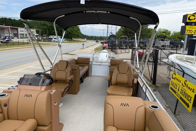 Slide: The Image of 2026 Avalon VENTURE QUAD LOUNGE pontoon boat with tan seating and black canopy. - 12