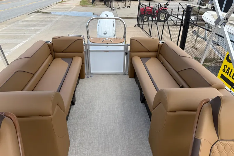 Slide: The Image of 2026 Avalon VENTURE QUAD LOUNGE interior with tan seating, displayed outdoors. - 15