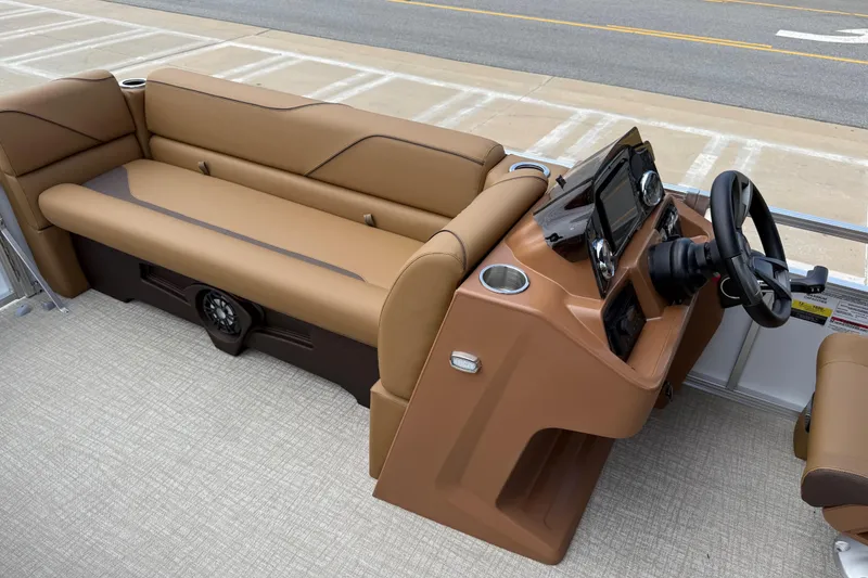 Slide: The Image of 2026 Avalon VENTURE QUAD LOUNGE boat interior with tan seating and modern dashboard. - 18