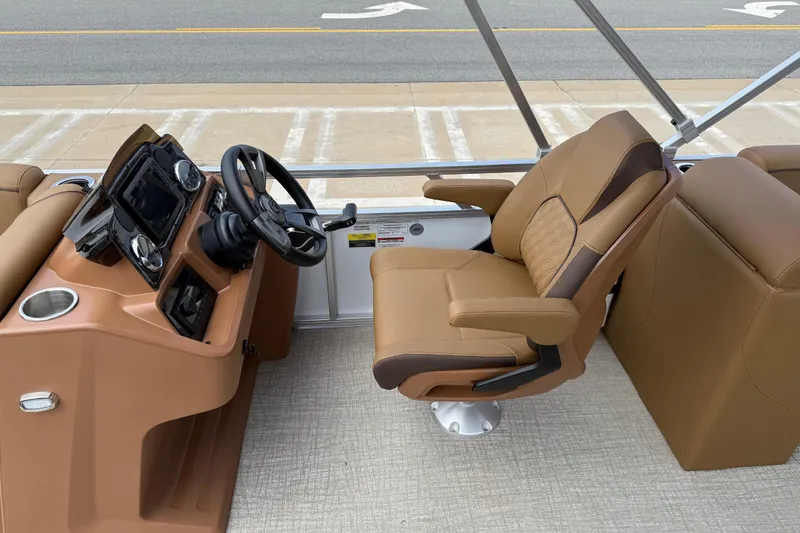 Slide: The Image of Captain's chair and helm of 2026 Avalon VENTURE QUAD LOUNGE boat, featuring modern controls. - 19