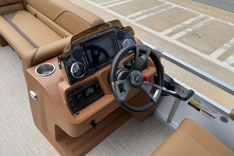 Slide: The Image of 2026 Avalon VENTURE QUAD LOUNGE boat interior with steering wheel and dashboard controls. - 20