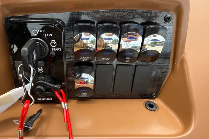 Slide: The Image of Control panel of 2026 Avalon VENTURE QUAD LOUNGE with Suzuki ignition and switches. - 25