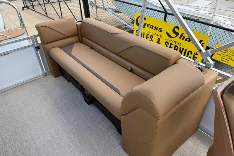 Slide: The Image of 2026 Avalon VENTURE QUAD LOUNGE boat interior with tan seating and cup holders. - 31