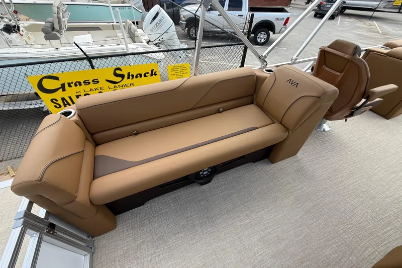 Slide: The Image of 2026 Avalon VENTURE QUAD LOUNGE boat interior with tan seating at marina. - 35