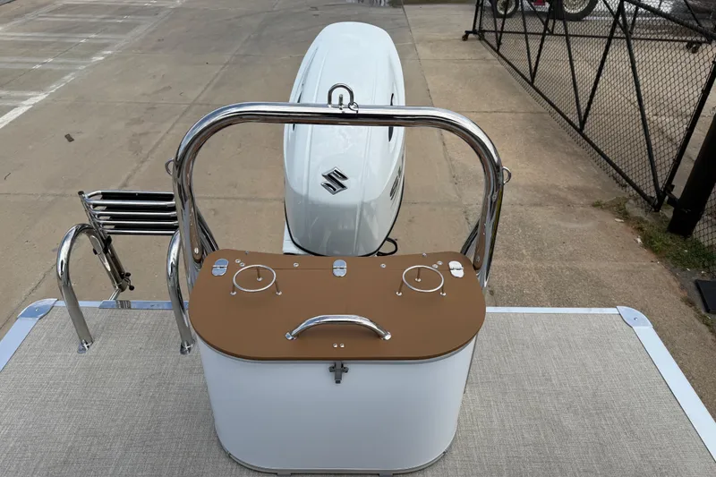 Slide: The Image of 2026 Avalon VENTURE QUAD LOUNGE boat with Suzuki engine, docked on concrete surface. - 39