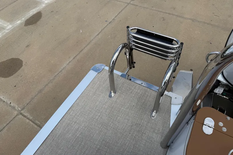Slide: The Image of 2026 Avalon VENTURE QUAD LOUNGE boat ladder on a textured deck surface. - 44