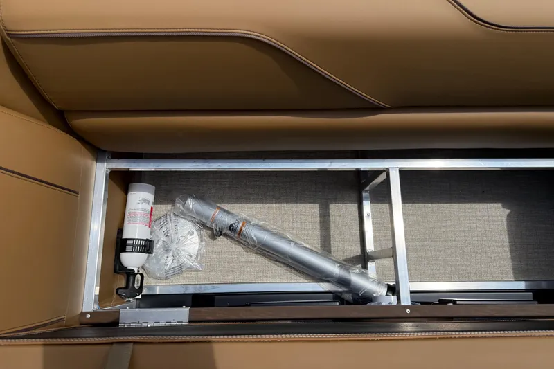 Slide: The Image of Avalon VENTURE QUAD LOUNGE 2026 storage compartment with accessories and tan seating. - 51