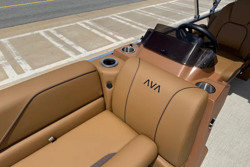 Slide: The Image of 2026 Avalon VENTURE QUAD LOUNGE interior with tan leather seats and cup holders. - 53