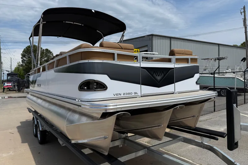 Slide: The Image of 2026 Avalon VENTURE QUAD LOUNGE pontoon boat on trailer, outdoor display. - 56