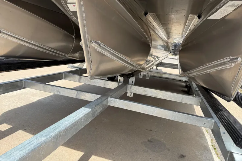 Slide: The Image of Underneath view of 2026 Avalon VENTURE QUAD LOUNGE pontoon boat on a trailer. - 57