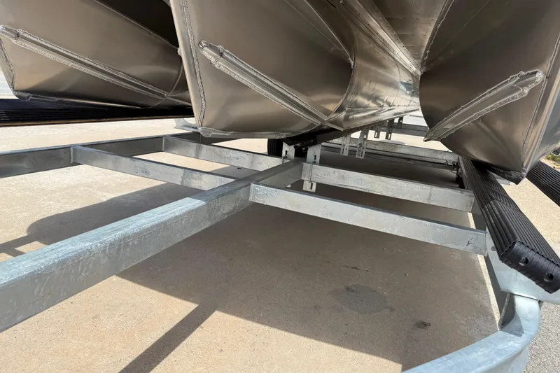 Slide: The Image of Underneath view of 2026 Avalon VENTURE QUAD LOUNGE pontoon boat on a trailer. - 58