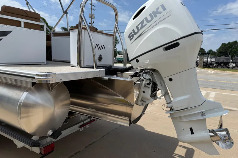 Slide: The Image of 2026 Avalon VENTURE QUAD LOUNGE with Suzuki outboard motor, docked on a trailer. - 59
