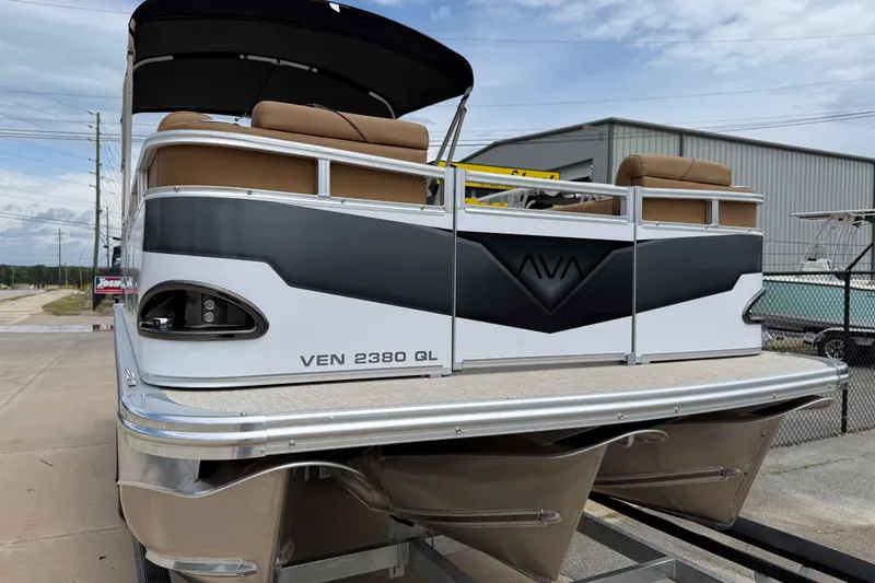 Slide: The Image of 2026 Avalon VENTURE QUAD LOUNGE pontoon boat, rear view, parked outdoors. - 6