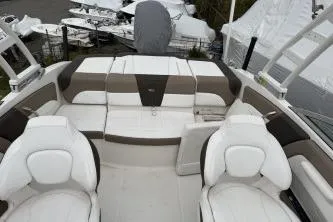 Slide: The Image of 2021 Chaparral 21 SSi OB boat interior with white and beige seating. - 13