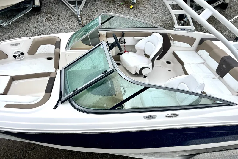 Slide: The Image of 2021 Chaparral 21 SSi OB boat interior with white and beige seating. - 7