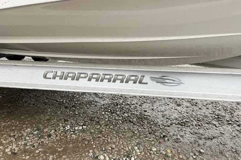 Slide: The Image of Chaparral 21 SSi OB 2021 boat trailer on gravel surface. - 9