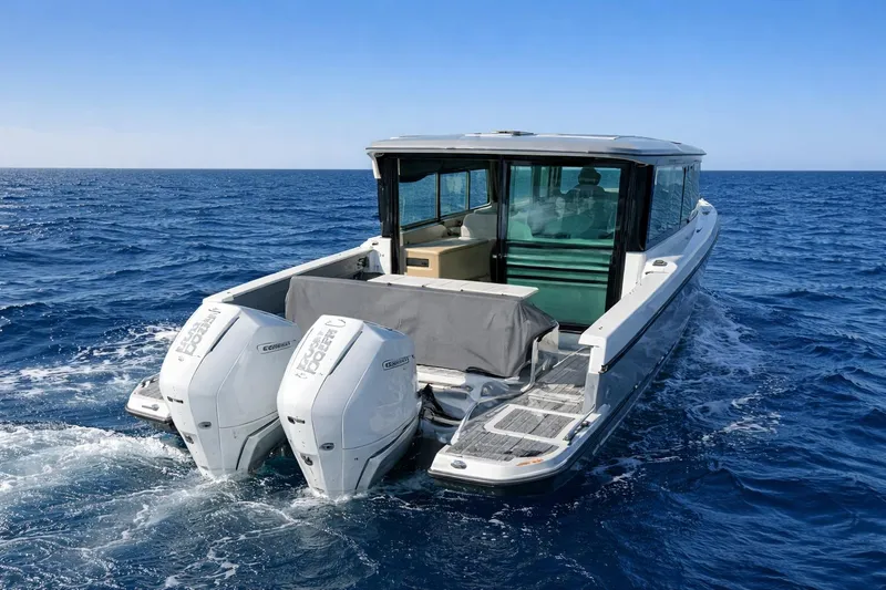 Slide: The Image of 2025 Saxdor 320 GTC boat cruising on open sea with dual outboard engines. - 11