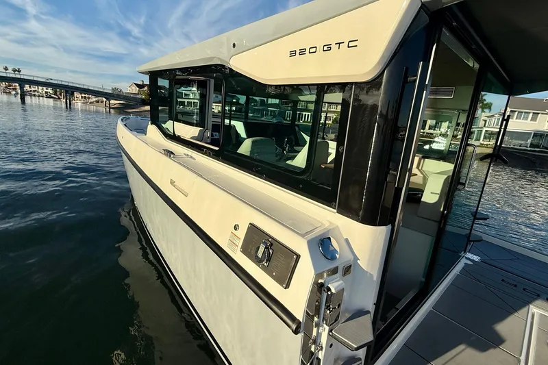 Slide: The Image of 2025 Saxdor 320 GTC boat docked, showcasing sleek design and modern features. - 15