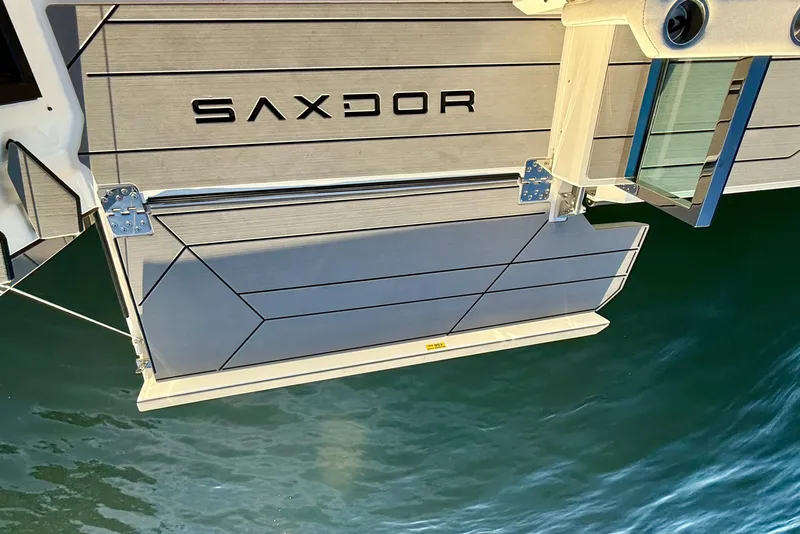 Slide: The Image of 2025 Saxdor 320 GTC boat with sleek design and modern detailing on water. - 19