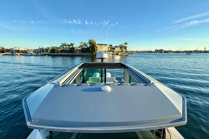 Slide: The Image of 2025 Saxdor 320 GTC yacht on serene water with coastal view. - 20