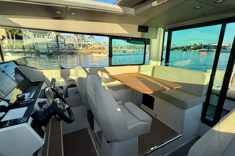 Slide: The Image of Interior of 2025 Saxdor 320 GTC boat with seating and waterfront view. - 27