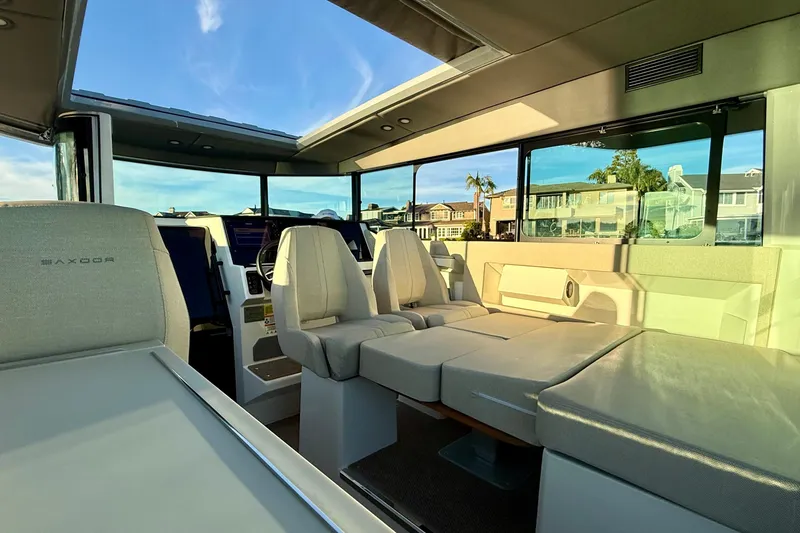 Slide: The Image of Interior of 2025 Saxdor 320 GTC boat with modern seating and panoramic windows. - 28