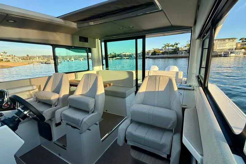 Slide: The Image of Interior of 2025 Saxdor 320 GTC boat with modern seating and scenic water view. - 30