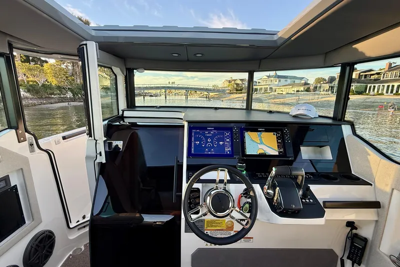Slide: The Image of Interior view of 2025 Saxdor 320 GTC boat cockpit with advanced navigation displays. - 34