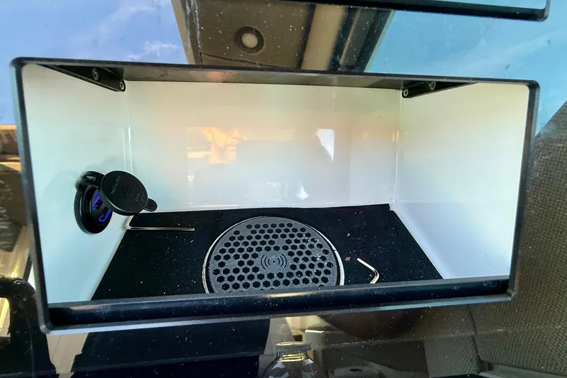 Slide: The Image of Storage compartment in 2025 Saxdor 320 GTC boat with USB port and speaker. - 35