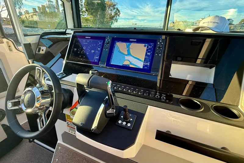 Slide: The Image of Interior view of 2025 Saxdor 320 GTC boat cockpit with navigation screens and controls. - 36