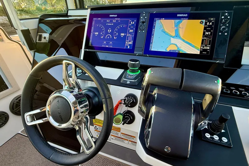 Slide: The Image of 2025 Saxdor 320 GTC helm with dual Simrad displays and modern controls. - 38