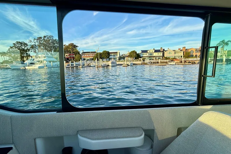 Slide: The Image of View from Saxdor 320 GTC, 2025 model, overlooking marina and waterfront homes. - 42