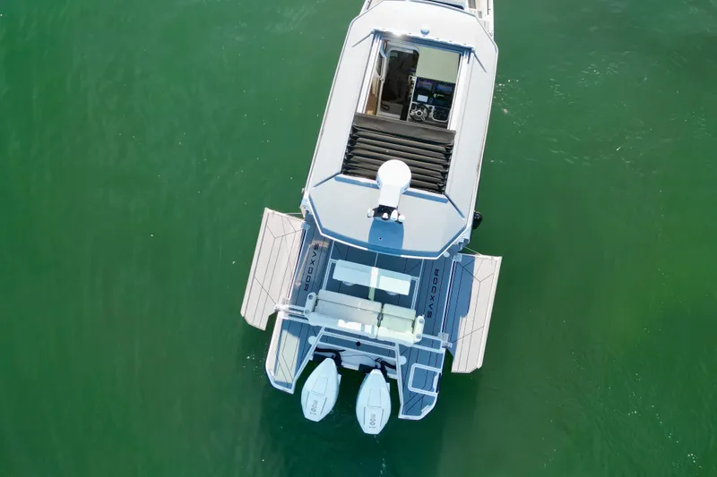 Slide: The Image of Aerial view of 2025 Saxdor 320 GTC boat on green water. - 5