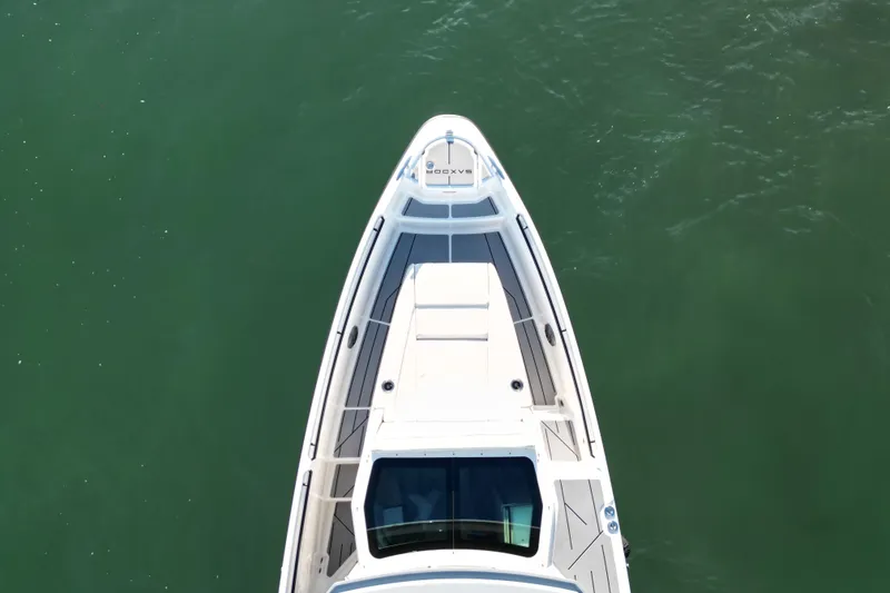 Slide: The Image of Top view of 2025 Saxdor 320 GTC boat on calm green water. - 6