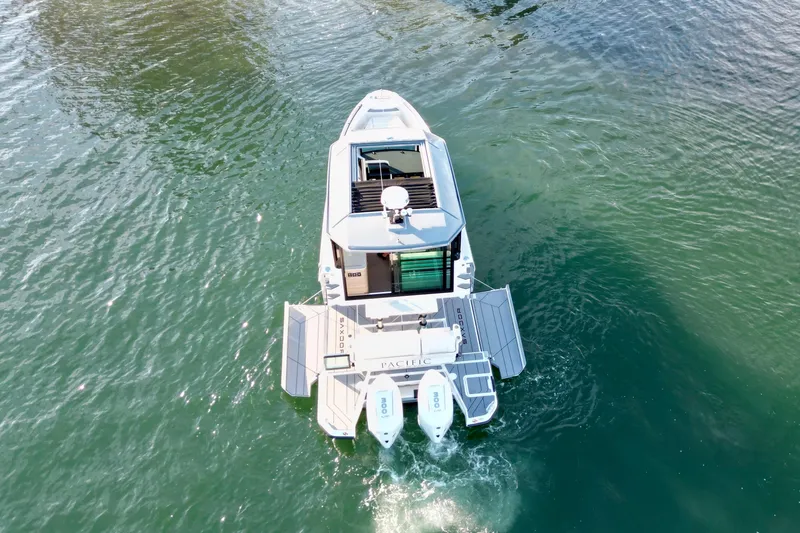 Slide: The Image of 2025 Saxdor 320 GTC boat on water, aerial view, showcasing modern design and twin engines. - 7
