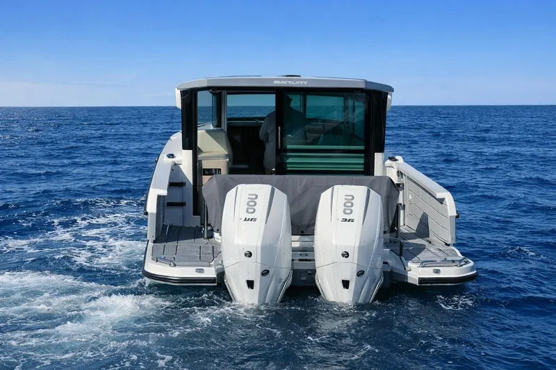 Slide: The Image of 2025 Saxdor 320 GTC boat with dual engines cruising on open sea. - 9