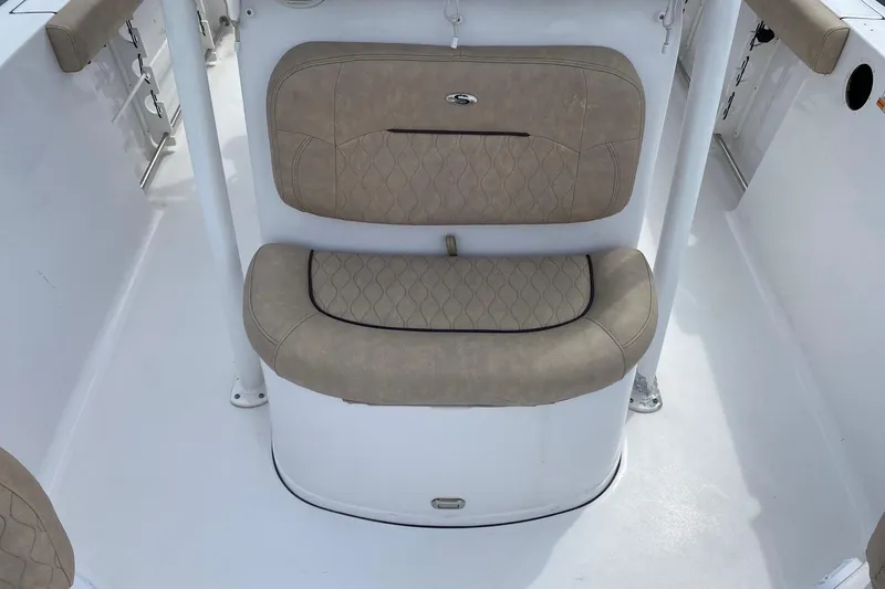 Slide: The Image of 2019 Sportsman Heritage 231 Center Console boat seating with beige cushioned upholstery. - 10