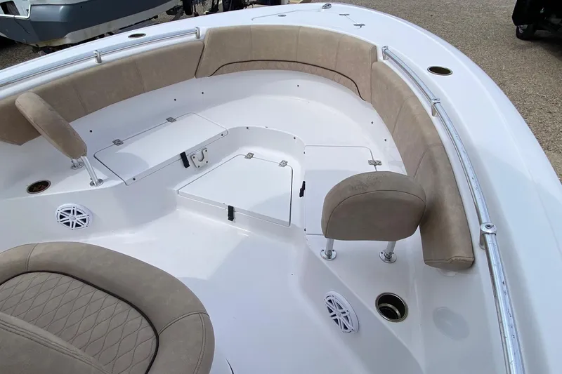 Slide: The Image of 2019 Sportsman Heritage 231 Center Console boat interior with cushioned seating and storage compartments. - 13