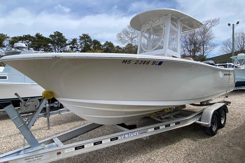 Slide: The Image of 2019 Sportsman Heritage 231 Center Console boat on trailer, parked outdoors. - 2