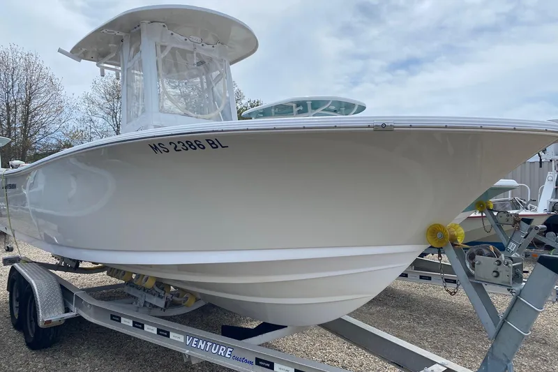 Slide: The Image of 2019 Sportsman Heritage 231 Center Console boat on trailer, side view. - 6