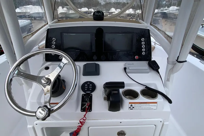 Slide: The Image of 2019 Sportsman Heritage 231 Center Console dashboard with steering wheel and navigation controls. - 8