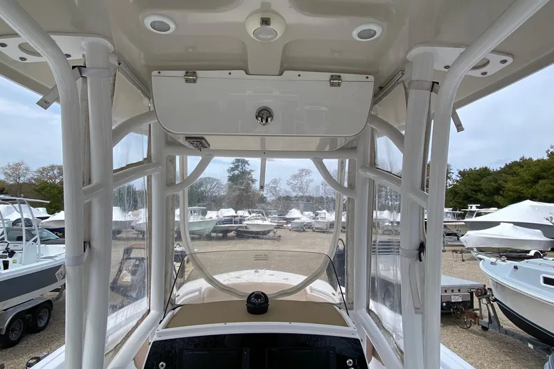 Slide: The Image of 2019 Sportsman Heritage 231 Center Console boat interior with clear enclosure and control panel. - 9