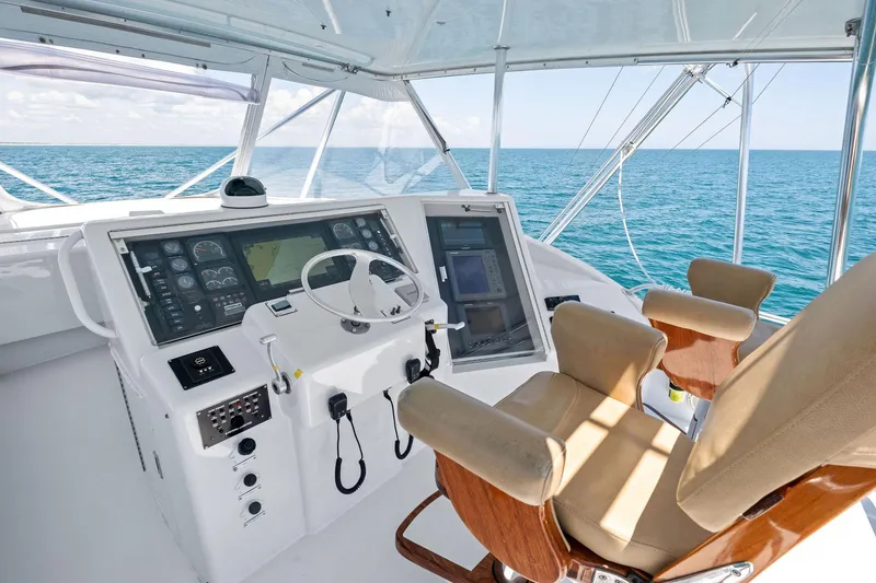 Slide: The Image of Helm of 1998 Hatteras 60 Convertible yacht with ocean view and modern controls. - 11
