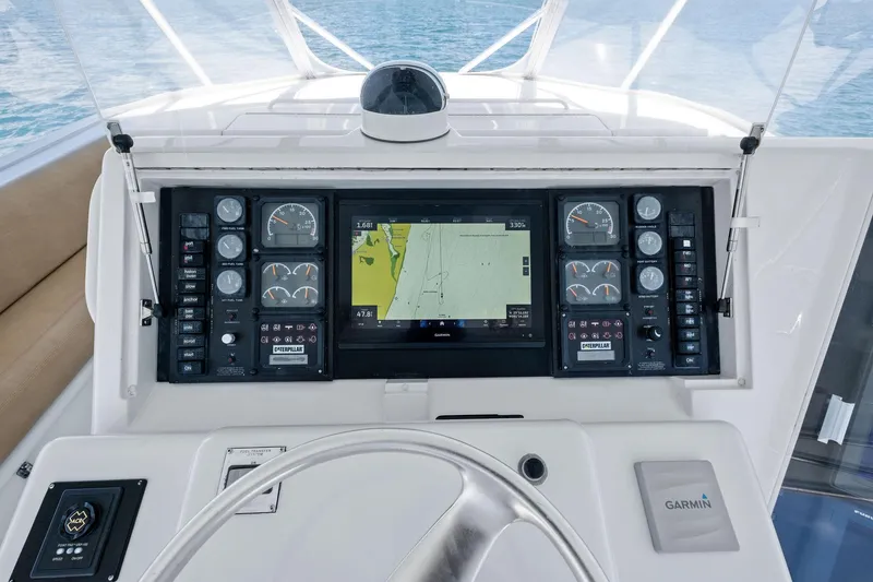 Slide: The Image of Control panel of a 1998 Hatteras 60 Convertible yacht with navigation and engine gauges. - 13