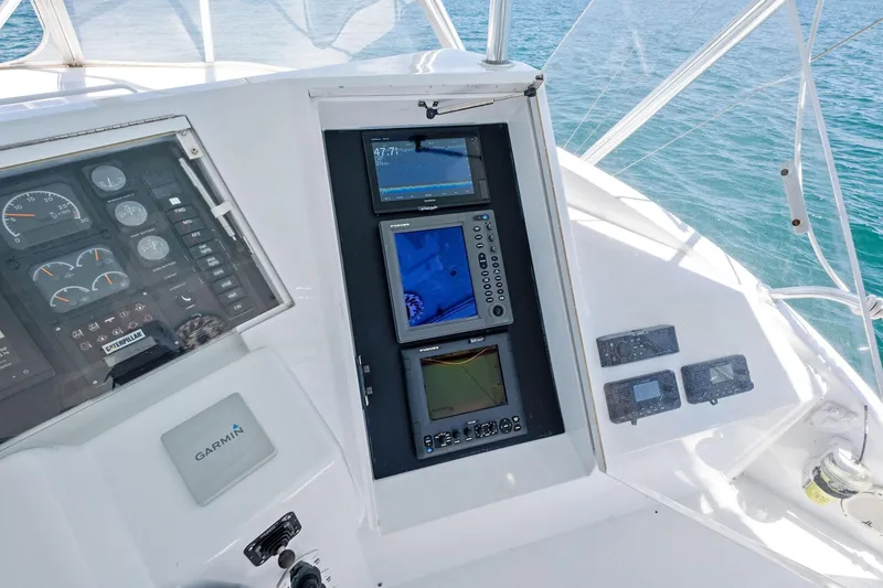 Slide: The Image of Control panel of a 1998 Hatteras 60 Convertible yacht with navigation equipment. - 14