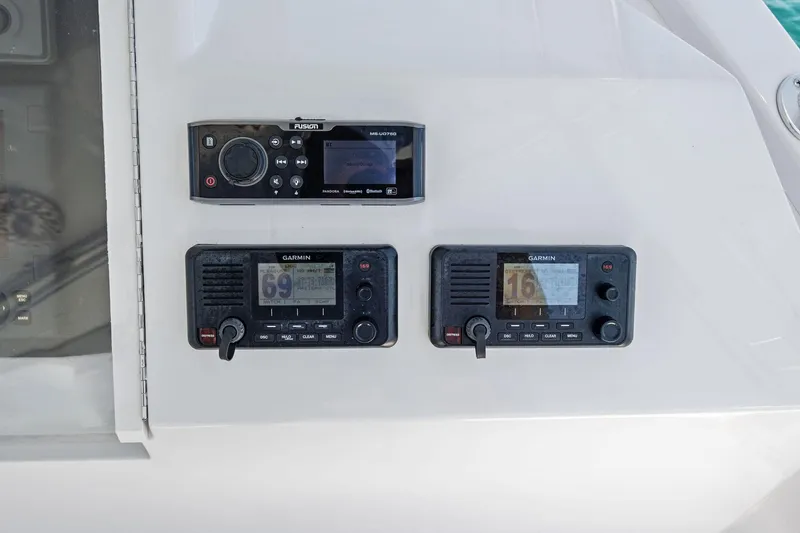 Slide: The Image of Control panel on a 1998 Hatteras 60 Convertible yacht with Garmin and Fusion devices. - 15