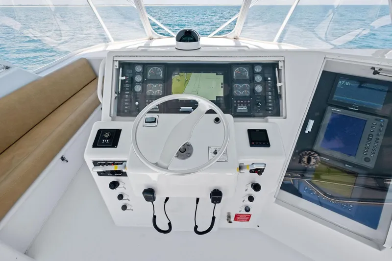 Slide: The Image of Helm of 1998 Hatteras 60 Convertible yacht with navigation instruments and steering wheel. - 16